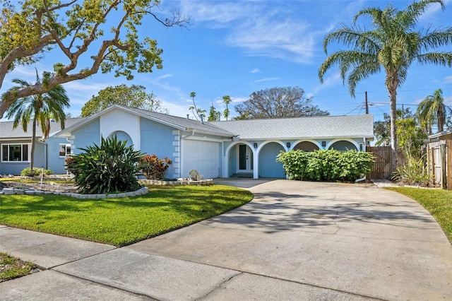 ranch-style home featuring a garage and a front yard