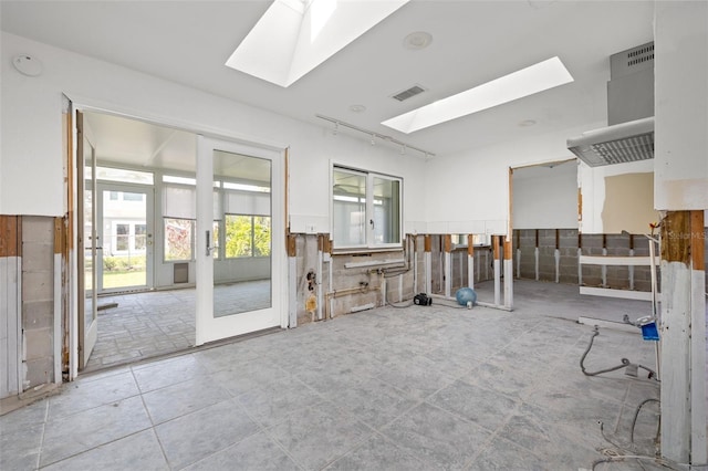 miscellaneous room featuring a skylight and french doors