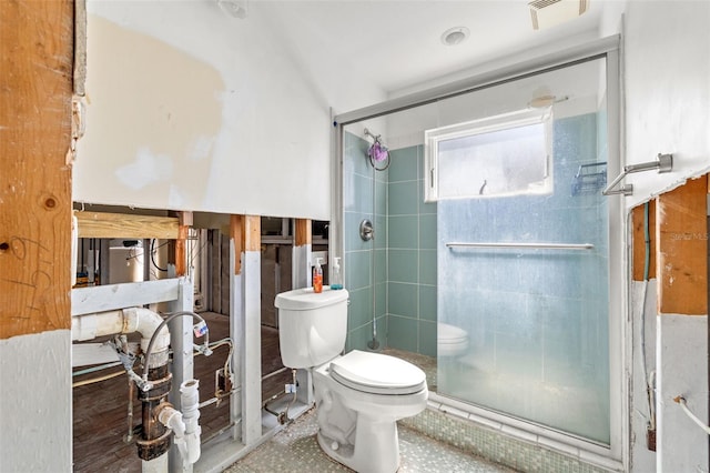 bathroom featuring toilet and an enclosed shower