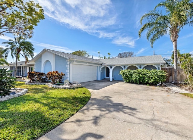 single story home with a garage and a front lawn