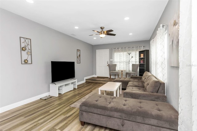 living room with hardwood / wood-style flooring and ceiling fan