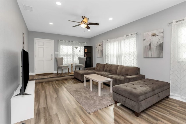 living room featuring light wood-type flooring and ceiling fan