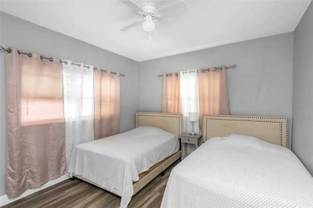 bedroom featuring ceiling fan and dark wood-type flooring