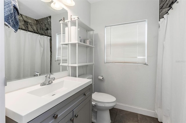 bathroom featuring toilet, vanity, a shower with shower curtain, and tile patterned flooring