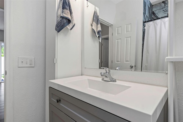 bathroom with a shower with curtain and vanity