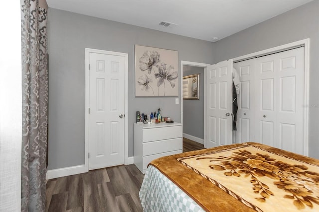 bedroom featuring a closet and dark hardwood / wood-style floors