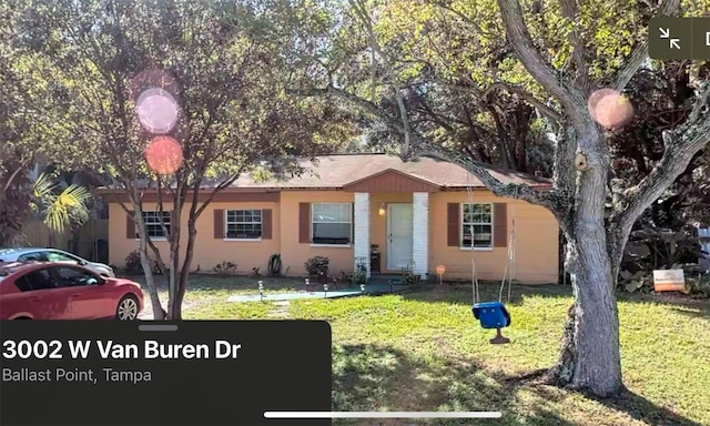 ranch-style home with a front lawn