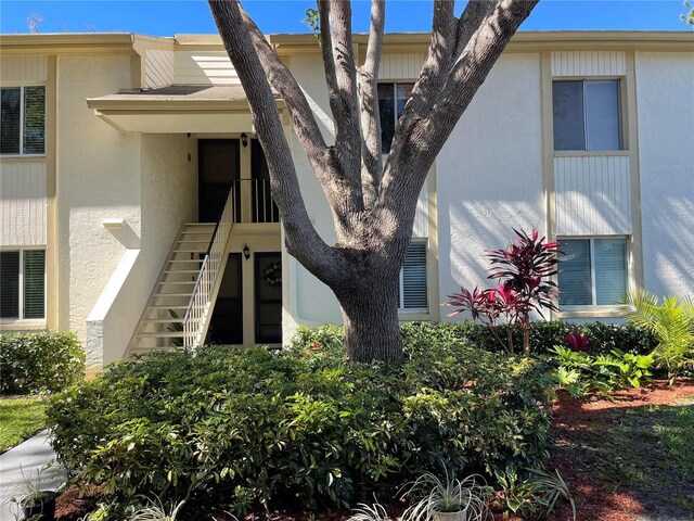 exterior space with stucco siding and stairs