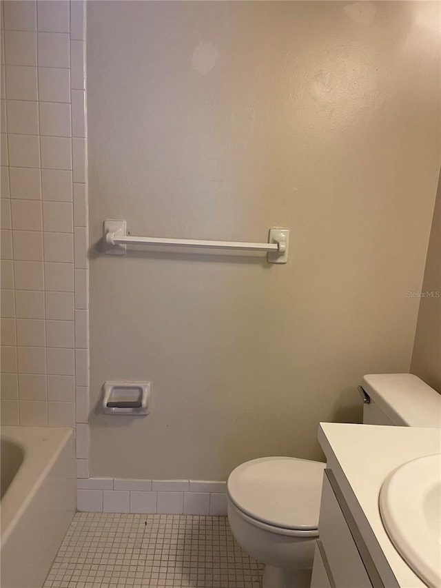 bathroom featuring tile patterned flooring, vanity, and toilet