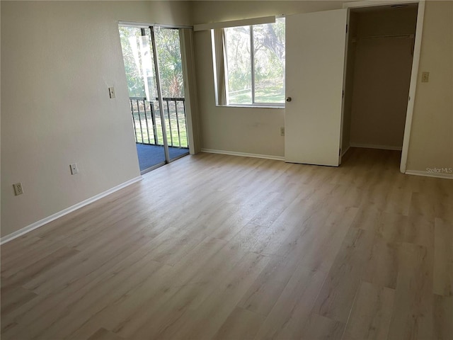 spare room with light hardwood / wood-style floors