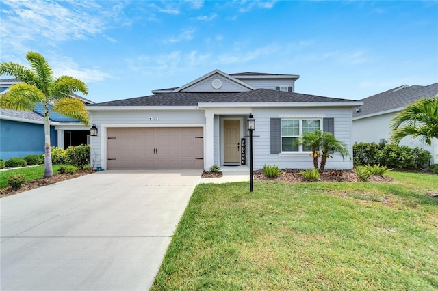 view of front of property featuring a front yard and a garage