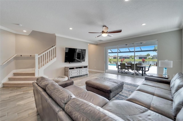 living room featuring crown molding, a textured ceiling, and ceiling fan