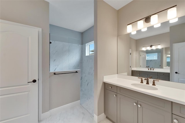 bathroom featuring a shower and vanity