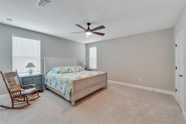 bedroom with ceiling fan and light colored carpet