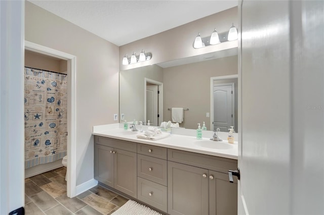 full bathroom with shower / bath combo with shower curtain, toilet, and vanity