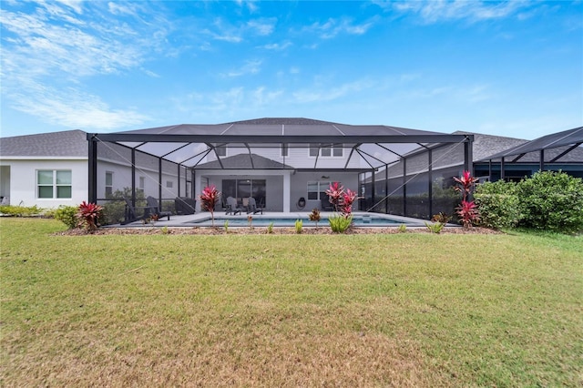 back of property featuring a patio area, a lanai, and a yard