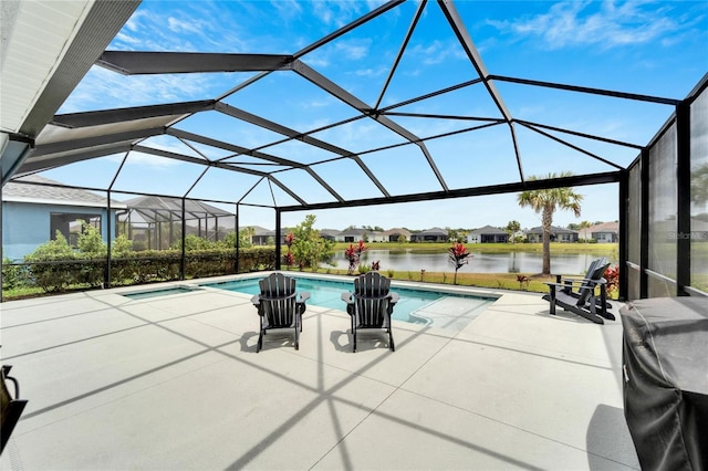 view of pool featuring a patio, glass enclosure, and a water view