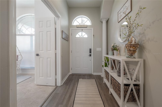 entryway with wood-type flooring and ornate columns