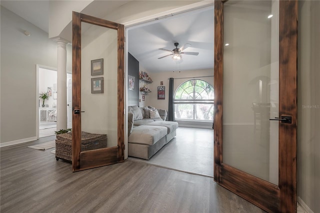 living room featuring ornate columns, ceiling fan, and hardwood / wood-style floors