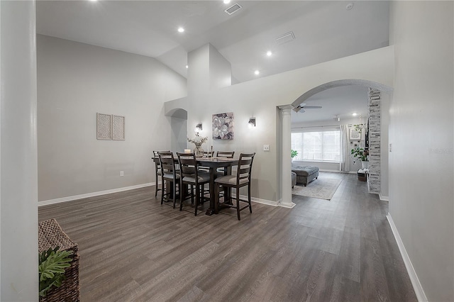 dining room with ceiling fan, dark hardwood / wood-style floors, decorative columns, and vaulted ceiling