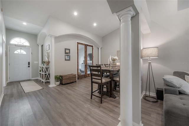 dining area featuring hardwood / wood-style floors and decorative columns