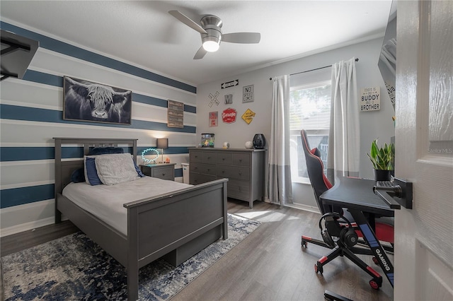 bedroom with ceiling fan and wood-type flooring