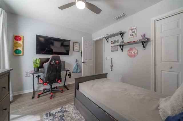 bedroom with ceiling fan and light hardwood / wood-style floors