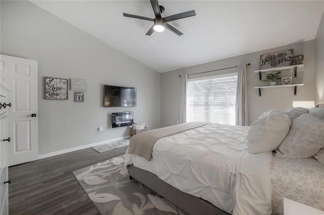 bedroom with ceiling fan, dark hardwood / wood-style floors, heating unit, and vaulted ceiling