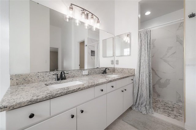 bathroom with vanity, curtained shower, and tile patterned floors