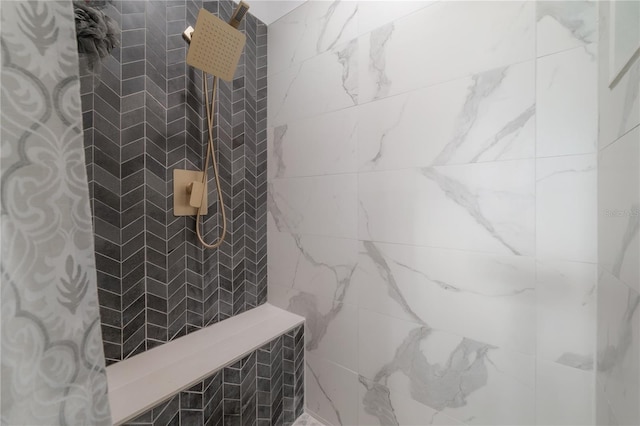 bathroom with a tile shower