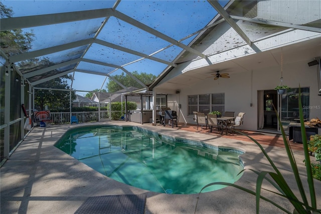 view of swimming pool with a patio area, a lanai, and ceiling fan