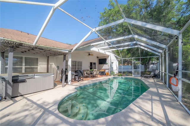 view of pool featuring a lanai, a patio, and a hot tub