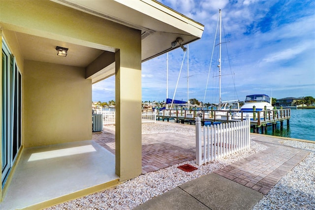 view of patio / terrace featuring a water view and a boat dock