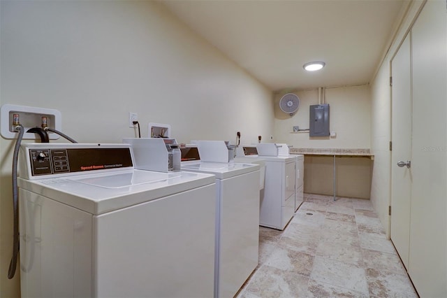 clothes washing area with electric panel and independent washer and dryer