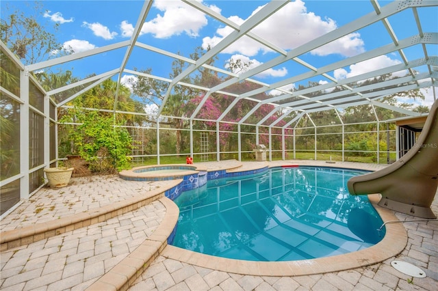 view of pool with an in ground hot tub, a lanai, and a patio area