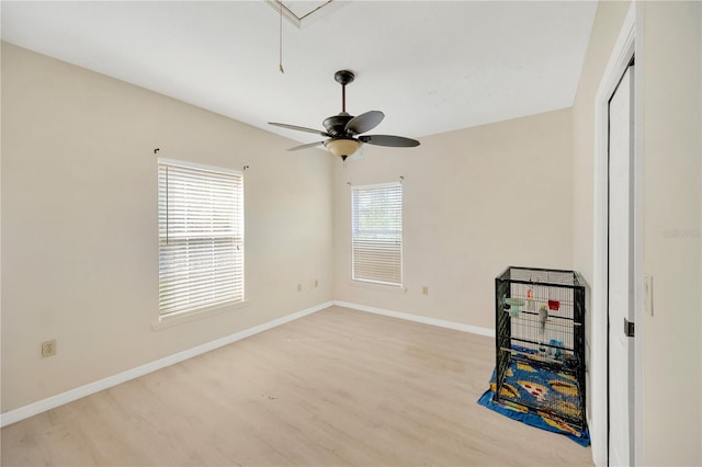 spare room with lofted ceiling, a wealth of natural light, and light wood-type flooring