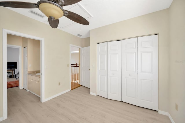 unfurnished bedroom with light hardwood / wood-style floors, a closet, and ceiling fan