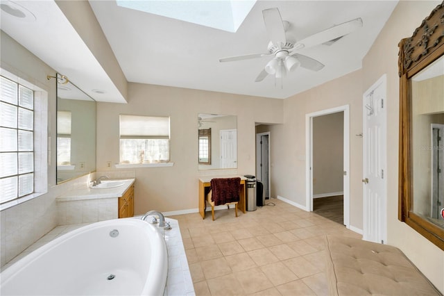 bathroom with vanity, tiled bath, tile patterned floors, and ceiling fan