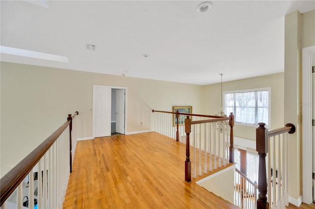 corridor with hardwood / wood-style floors