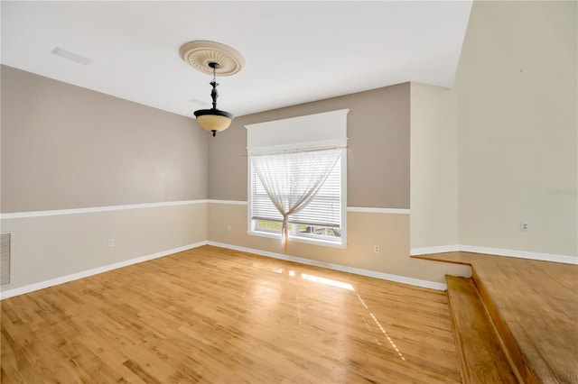 unfurnished room with hardwood / wood-style flooring