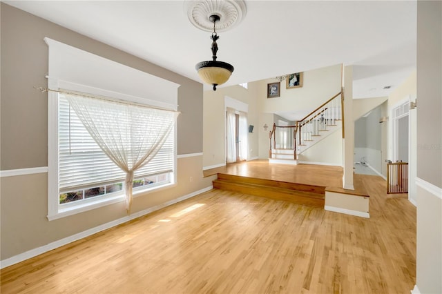 unfurnished living room with hardwood / wood-style flooring