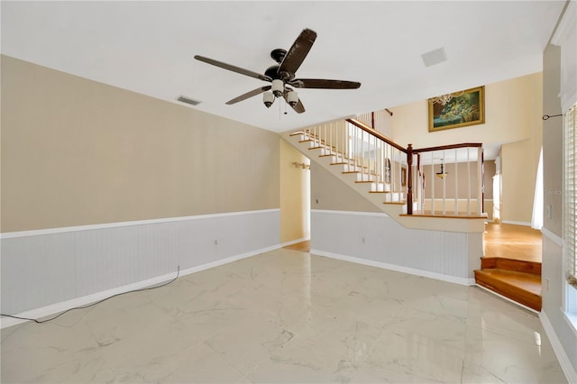 unfurnished living room with ceiling fan