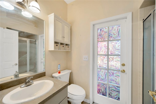 bathroom with vanity, toilet, and an enclosed shower