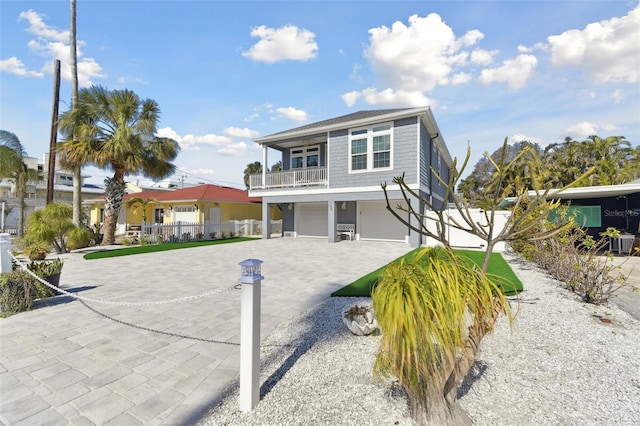 view of property with a garage and a balcony