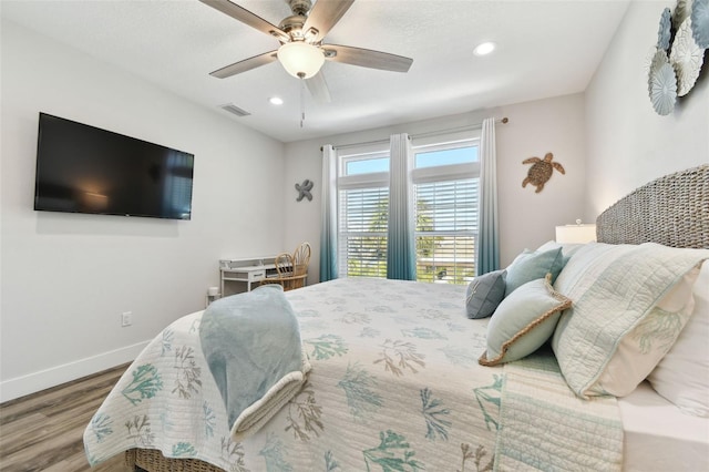 bedroom with hardwood / wood-style floors and ceiling fan