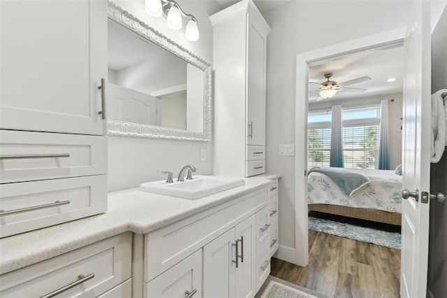 bathroom with vanity, hardwood / wood-style floors, and ceiling fan