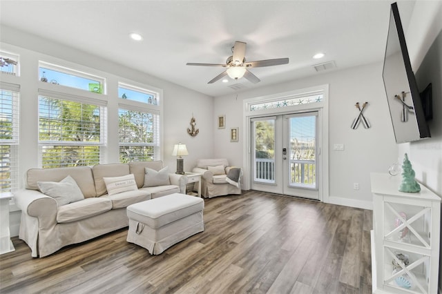 living room featuring a wealth of natural light, wood-type flooring, french doors, and ceiling fan