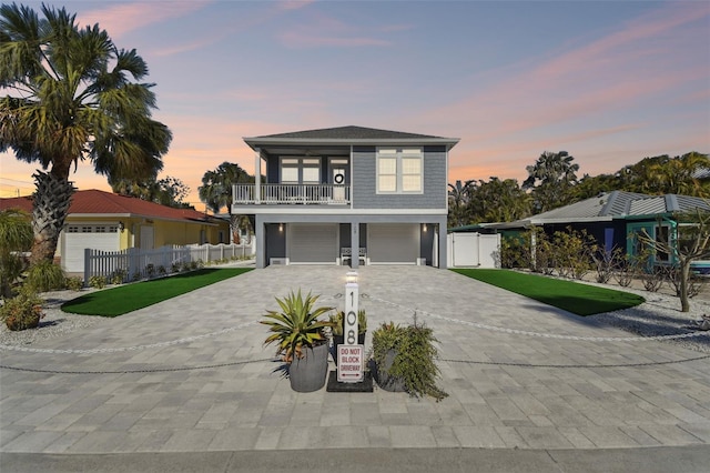 view of front facade featuring a lawn and a balcony