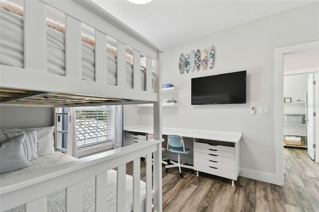 bedroom with hardwood / wood-style flooring