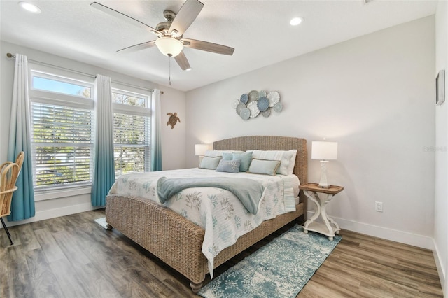 bedroom with ceiling fan and dark hardwood / wood-style floors